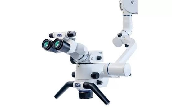 Global Surgical dental operating microscope mounted on a flexible white articulated arm.